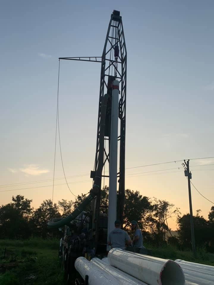 R.A.M. Drilling crew working at the rig at sunset
